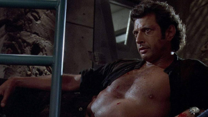 Photo of Jeff Goldblum from Jurassic Park lounging with his shirt open